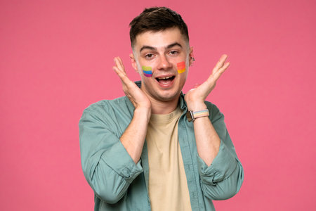 Young Man Expressing Joy with LGBTQ Face Paintの写真素材