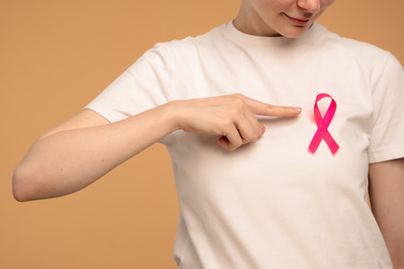 Woman Wearing Pink Ribbon for Breast Cancer Awarenessの写真素材