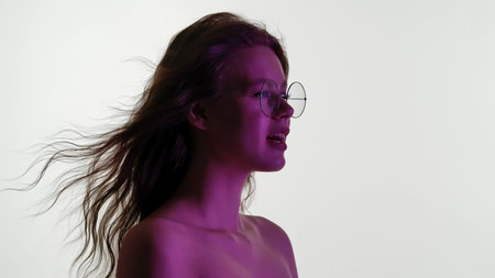 Portrait of a Woman with Windblown Hair and Glassesの写真素材