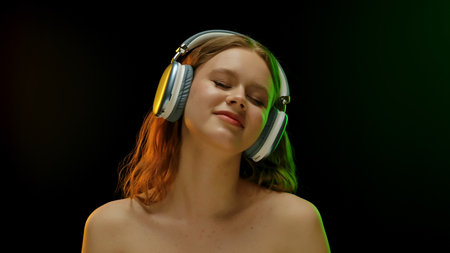 Portrait of Woman Enjoying Music with Headphones Onの写真素材