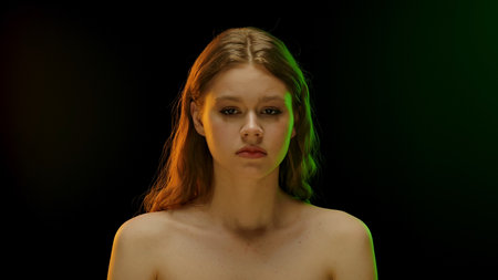 Woman in Dramatic Colored Lighting Portrait with Intense Expressionの写真素材