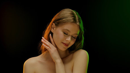 Smiling Woman with Brown Hair in Colorful Lightingの写真素材