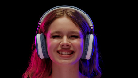 Young Woman Enjoys Music With Large Headphonesの写真素材