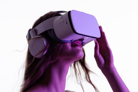 Woman Experiencing Immersive Virtual Reality with Headsetの写真素材