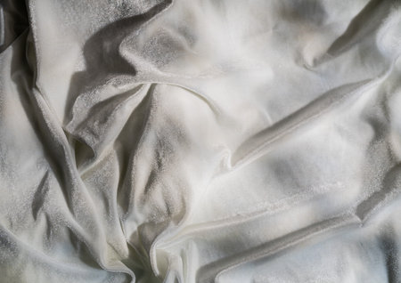 Elegant White Fabric with Soft Creases and Gentle Textureの写真素材
