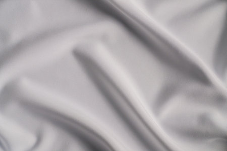Smooth White Fabric with Elegant Foldsの写真素材