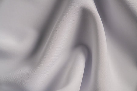 Smooth White Fabric with Elegant Foldsの写真素材