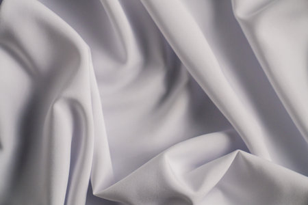 Smooth White Fabric with Elegant Foldsの写真素材