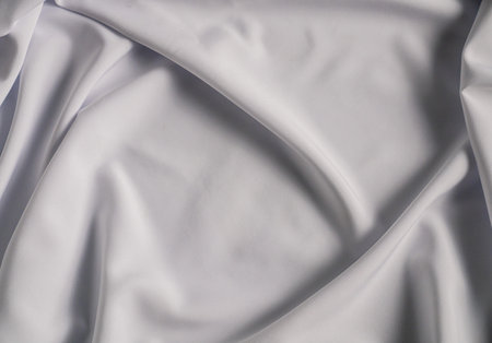 Smooth White Fabric with Elegant Foldsの写真素材