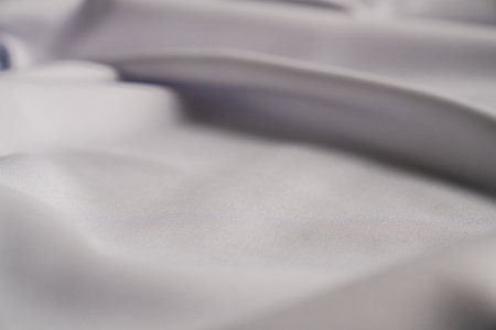 Smooth White Fabric with Elegant Foldsの写真素材
