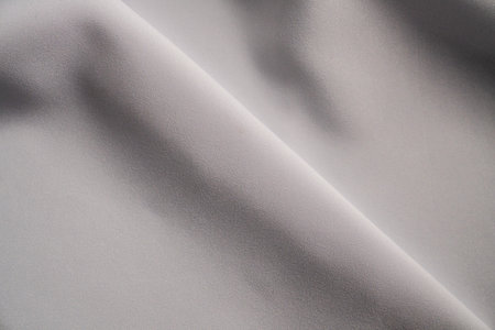 Smooth White Fabric with Elegant Foldsの写真素材