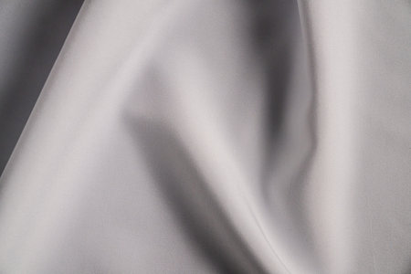 Smooth White Fabric with Elegant Foldsの写真素材