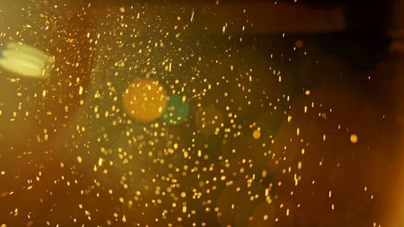 Warm glowing dust particles in golden lightの写真素材