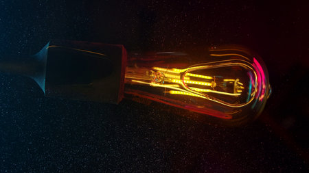 Glowing vintage style LED bulb with vibrant reflectionsの写真素材