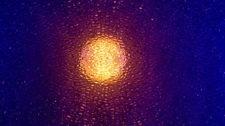 Abstract glowing light behind textured glass in deep purple tonesの写真素材