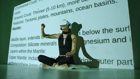 Woman Experiencing Virtual Reality with Text Projectionsの写真素材