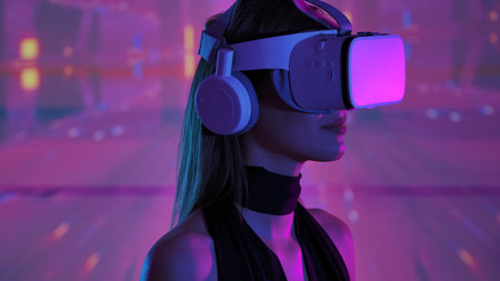 Woman Engaging with Virtual Reality Headset and Abstract Backgroundの写真素材