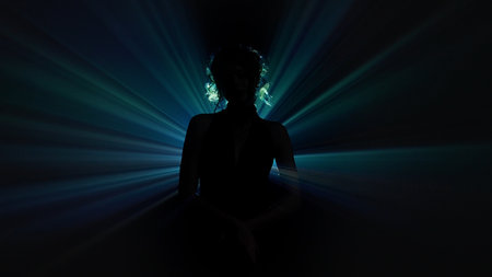 Silhouette of woman with radiating blue light beamsの写真素材