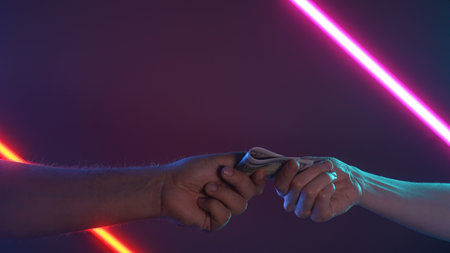 Hand to Hand Money Exchange Under Neon Lights