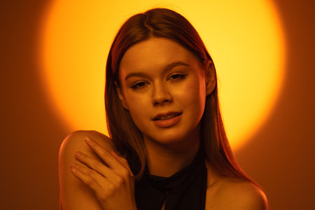 Elegant Portrait of a Woman in Warm Light Settingの写真素材