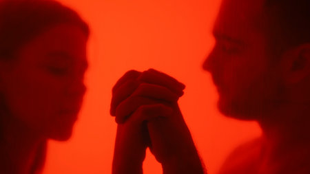 Abstract Art with Two Blurred People in Red Lightの写真素材