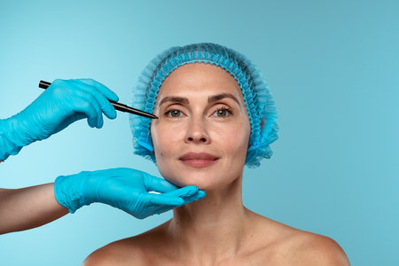 Preparation for Cosmetic Surgery with Marker and Gloved Handsの写真素材