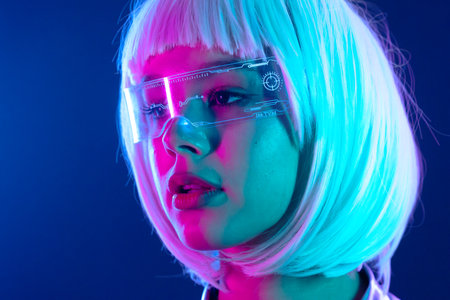 Futuristic woman in neon light with holographic smart glasses