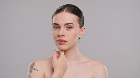 Portrait of a Woman Touching Her Chin with Tattoo Visibleの写真素材