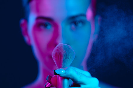Vibrant Makeup Brush with Woman in Colorful Lighting