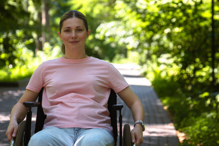 Woman Relaxing Outdoors in a Wheelchair Amidst Greeneryの写真素材