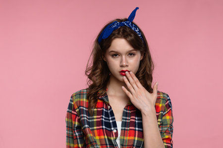 Young Woman in Plaid Shirt Posing Against Pink Background