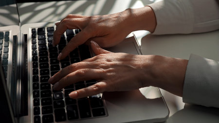 Hands Typing on a Laptop Keyboard in Natural Light
