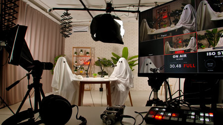 Two funny ghosts record a podcast in a studio