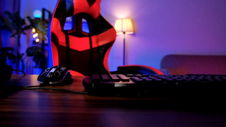 Gaming Setup with Chair, Keyboard, and Mouse Under Soft Lightingの写真素材
