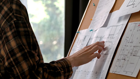 Architectural Plans Being Reviewed on a Notice Board