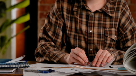 Close up of Person Measuring on Architectural Plans