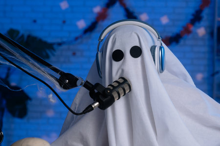 Ghost costume recording podcast or blog in a studio with blue light
