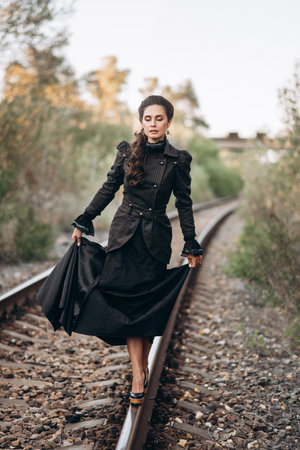 Vintage Woman Walking Gracefully On Railway Trackの写真素材