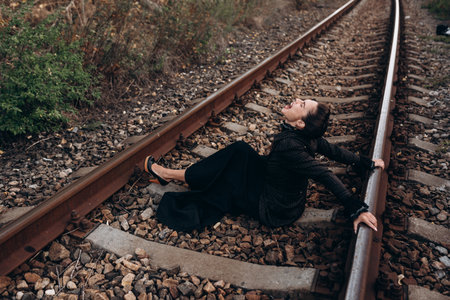 Woman in Emotional Expression on Railway Tracks Photoの写真素材