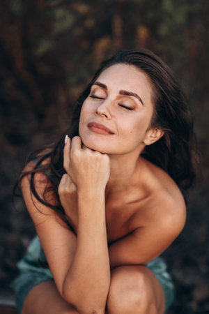Contemplative Woman with Natural Beauty Portrait Outdoorsの写真素材