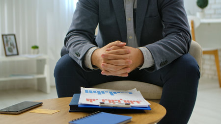 Business Professional Analyzing Financial Charts in Office Setting