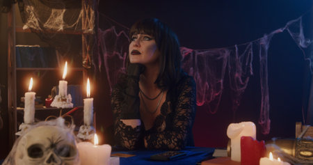 Mysterious Woman in Gothic Attire with Candles and Webs