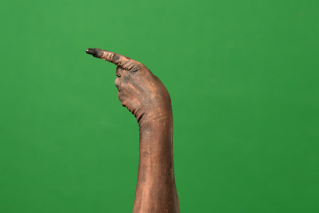 A creepy zombie hand points to the sideの写真素材