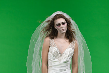 Dead Bride in a Wedding Dress on a Green Backgroundの写真素材