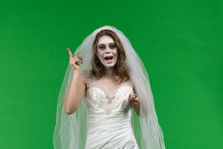 Dead Bride in a Wedding Dress on a Green Backgroundの写真素材