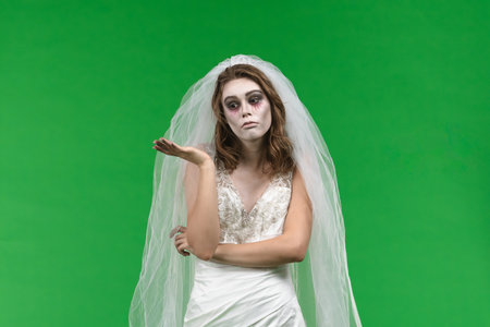 Dead Bride in a Wedding Dress on a Green Backgroundの写真素材