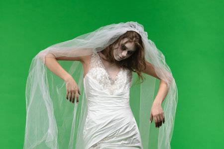 Dead Bride in a Wedding Dress on a Green Backgroundの写真素材