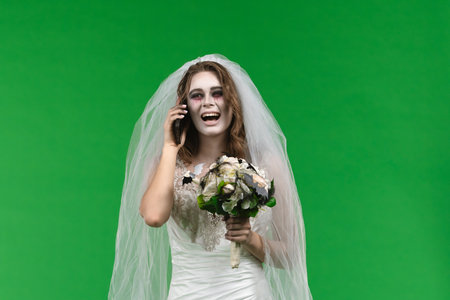 Dead Bride in a Wedding Dress on a Green Backgroundの写真素材
