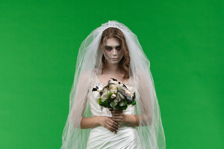 Dead Bride in a Wedding Dress on a Green Backgroundの写真素材