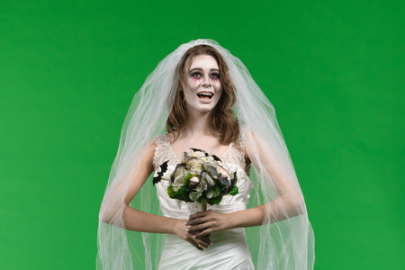 Dead Bride in a Wedding Dress on a Green Backgroundの写真素材
